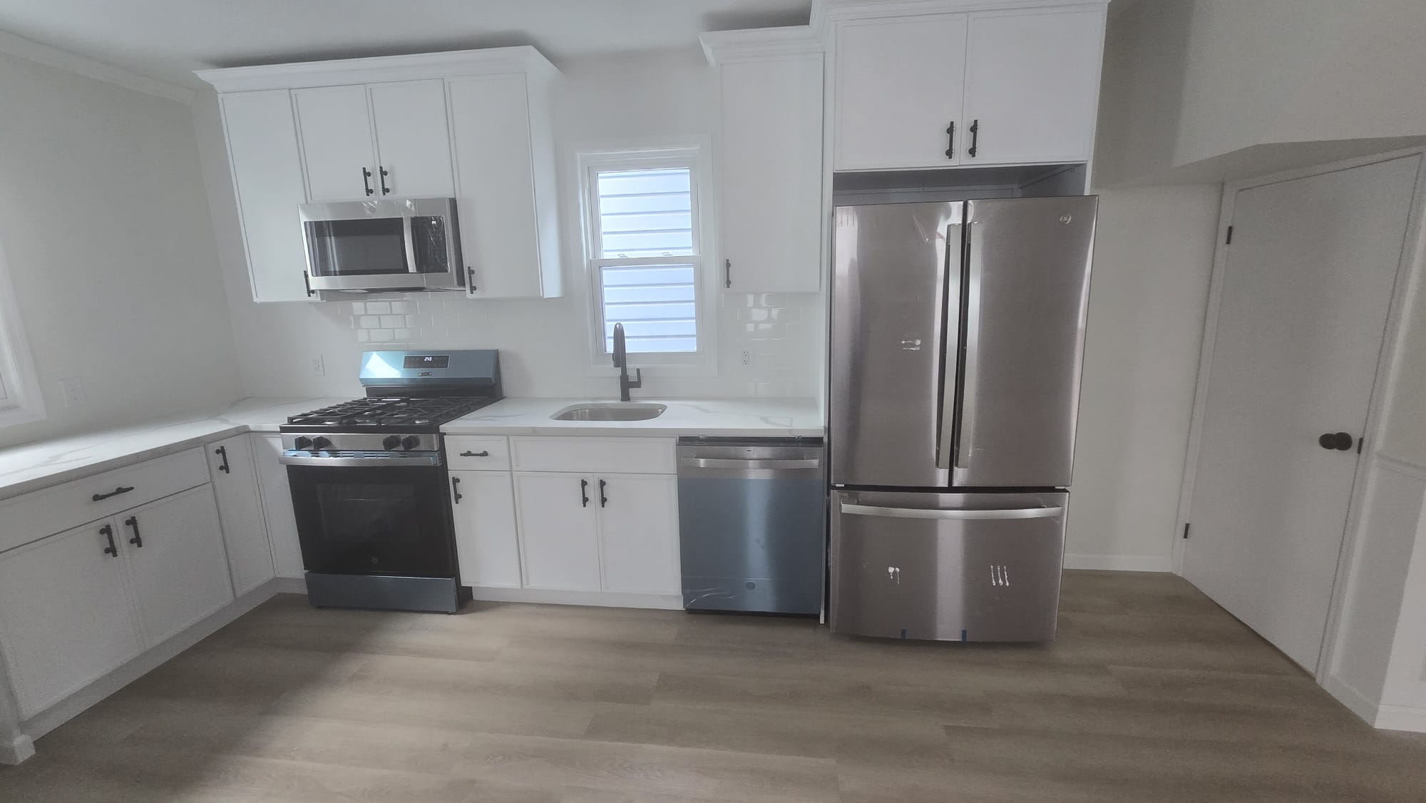 Completed Kitchen — White Cabinets & Stainless Appliances